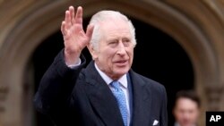 FILE — Britain's King Charles III is pictured waving outside St. George's Chapel, Windsor Castle, England, on March 31, 2024.