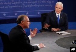 Republican vice-presidential nominee Gov. Mike Pence, right, speaks as Democratic vice-presidential nominee Sen. Tim Kaine listens during the vice-presidential debate.