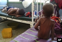 A malnourished child from southern Somalia sits on the bed at Banadir hospital in Mogadishu, Somalia.