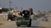 Members of the Iraqi security forces ride a military vehicle near Hammam al-Alil, south of Mosul, Dec. 11, 2016. 