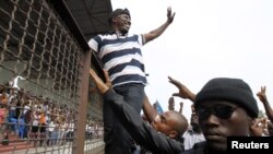 FILE - Leader of the Young Patriots militia Charles Ble Goude (C) greets members of the militia and supporters of Ivory Coast's incumbent leader Laurent Gbagbo, during a rally in support of the Ivorian armed forces, at Champroux Stadium in Abidjan.