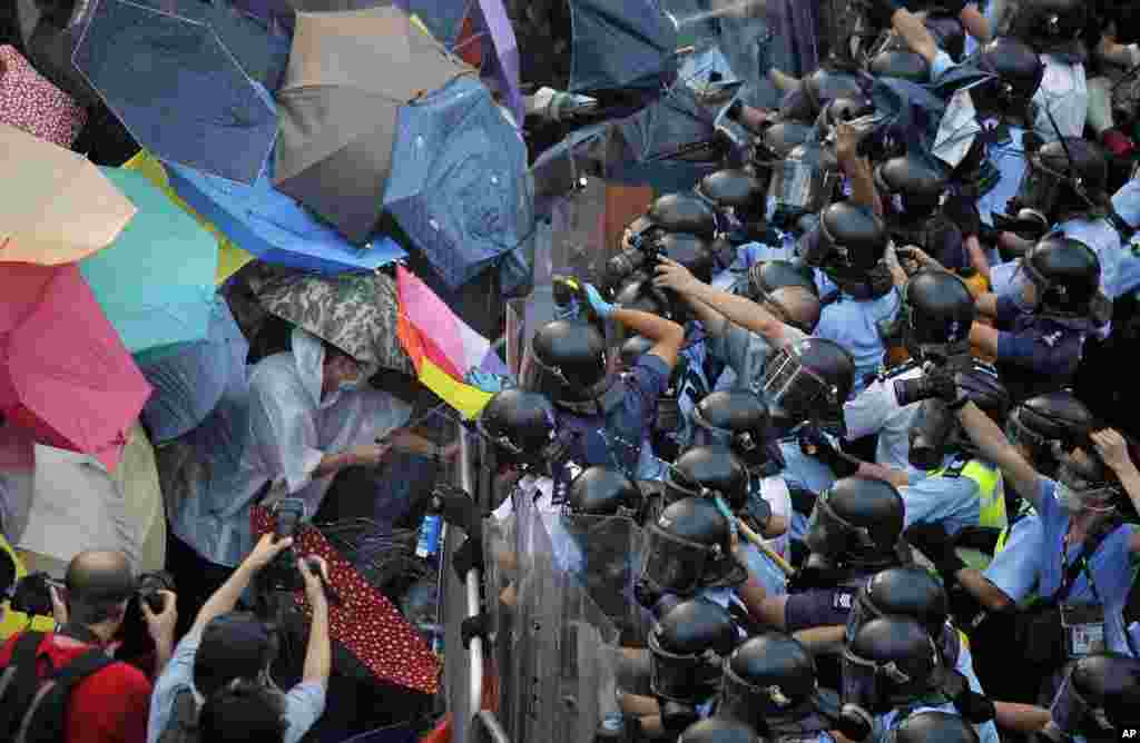 Riot police use pepper spray against protesters outside the government headquarters in Hong Kong.