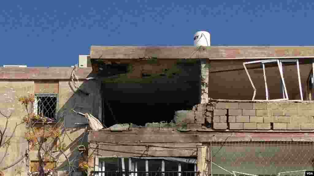 Damage is shown to the top of a building in Kiriat Malakhi, November 15, 2012. (VOA - L. Fridmam)