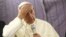 Pope Francis touches his forehead as he talks with journalists during his flight from Lima, Peru, to Rome, Italy, Jan. 21, 2018. 