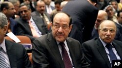 Iraqi Prime Minister Nouri al-Maliki, center, attends the first session of parliament in the heavily fortified Green Zone in Baghdad, Iraq, July 1, 2014. 