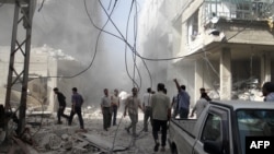 A handout picture released by the Syrian opposition-run Shaam News Network shows Syrians inspecting the damage following an air strike in Arbeen in the suburbs of Damascus on July 6, 2013.