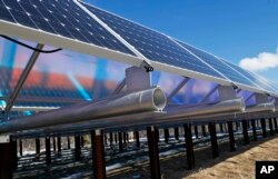 FILE - Solar panels that are part of the Wright-Hennepin Cooperative Electric Association's community gardens are shown in Rockford, Minn., Feb. 26, 2015.