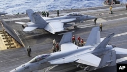 FA-18 air fighters prepare to take off on the U.S. carrier George Washington in the Pacific near Minamidaito Island in Okinawa Prefecture, southern Japan, during a joint drill with the Japanese Self-Defense Forces. (2010 File)