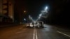 A police bus, which was burned after clashes, remains in an empty street in Almaty, Kazakhstan, late Saturday, Jan. 8, 2022. 
