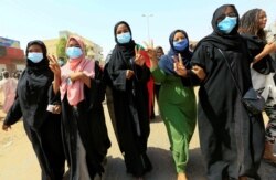 Civilians chant slogans as members of Sudanese pro-democracy protest on the anniversary of a major protest in Khartoum, June 30, 2020.