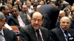 Iraqi Prime Minister Nouri al-Maliki, center, attends the first session of parliament in the heavily fortified Green Zone in Baghdad, Iraq, July 1, 2014. 