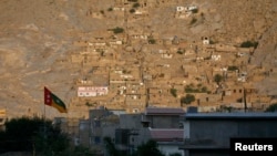FILE - A view shows homes of the Hazara community on a hill in Mehrabad, Quetta.