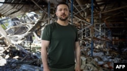 This handout photograph released by the Ukrainian Presidential press service in Kharkiv on May 26, 2024, shows Ukraine's President Volodymyr Zelensky visiting a printing house that was destroyed by shelling in Kharkiv.