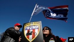 Supporters of President Donald Trump, Katie Miller, right, and her husband, Mark Miller, from Boonsboro, Md., join a rally at the National Mall in Washington, organized by the North Carolina-based group Gays for Trump, March 4, 2017.