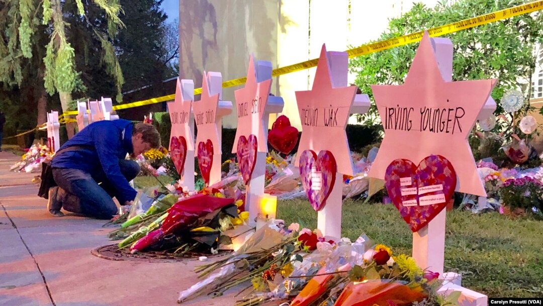 One man pays his respect in front of a Star of David memorial for one of the 11 victims killed in the Oct. 27, 2018, synagogue shooting.