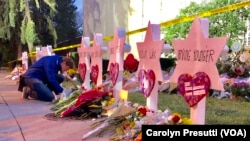 One man pays his respect in front of a Star of David memorial for one of the 11 victims killed in the Oct. 27, 2018, synagogue shooting.