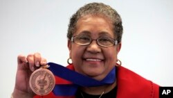 Beverly Hall, former Atlanta superintendent of public schools, holds up her award after she was named the 2009 Superintendent of the Year at the American Association of School Administrators' National Conference on Education in San Francisco, (File photo)