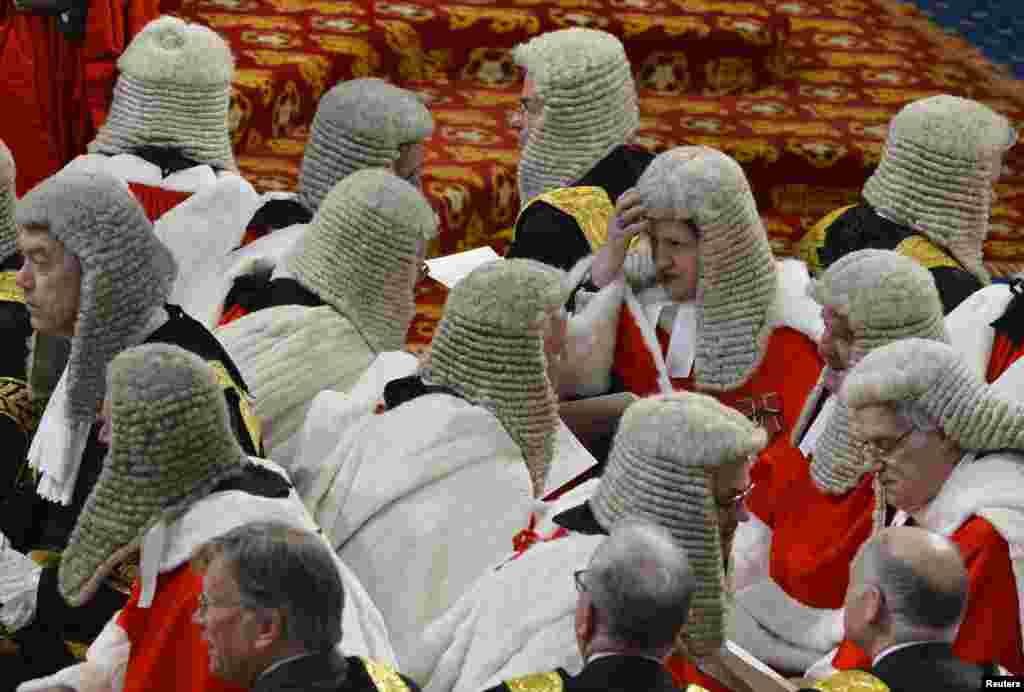 Judges sit in the House of Lords as they wait for the start of the State opening of Parliament, in the Palace of Westminster in London. 