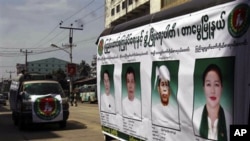Members of the Union Solidarity and Development Party drive a campaign vehicle with posters of the party's candidates who are running in the Nov. 7 general elections, in Yangon, Burma.