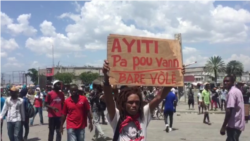 Protesters camped out in front of Haiti's parliament before the deputies arrived for the impeachment vote. The sign reads: "Haiti is not for sale. Catch the Thieves", Aug. 21, 2019.