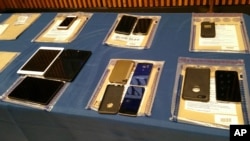 Apple iPhones and iPads are seen during a news conference at New York City Police Headquarters, Feb. 18, 2016. New York City Police and prosecutors said Apple's encryption technology routinely hinders criminal investigations.