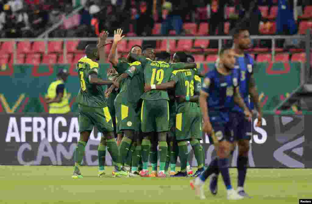Senegalese team celebrates scoring their first goal against Cape Verde in Cameroon, Jan. 25, 2022.
