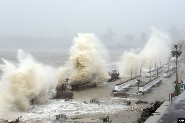 FILE - Waves lash over onto a shoreline in Mumbai on May 17, 2021, as Cyclone Tauktae, packing ferocious winds and threatening a destructive storm, surge bore down on India, disrupting the country's response to its devastating Covid-19 outbreak. (Photo by Sujit Jaiswal / AFP)