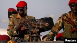 FILE- SPLA soldiers stand in a vehicle in Juba, South Sudan, Dec. 20, 2013.