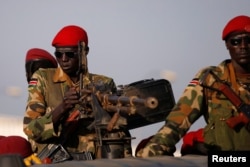 FILE- SPLA soldiers stand in a vehicle in Juba, South Sudan, Dec. 20, 2013.