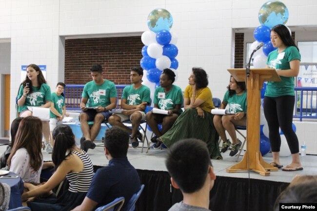 FILE - Student leaders and a professor at Duke University lead a presentation for new international students.