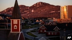 FILE - The sun sets over Nuuk, Greenland, July. 31, 2017. 