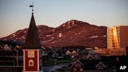 FILE - The sun sets over Nuuk, Greenland, July. 31, 2017. 