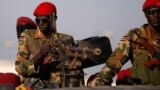 FILE- SPLA soldiers stand in a vehicle in Juba, South Sudan, Dec. 20, 2013.