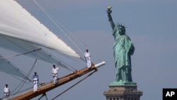 2026년 7월 4일 미국 건국 250주년을 기념하기 위해 열린 '항해 250 (Sail250)' 행사의 '국제 범선 퍼레이드' 중 범선의 선원들이 뉴욕항에서 자유의 여신상 앞을 지나가고 있다.