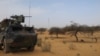 FILE - A light armored vehicle (LAV) of the French force of the counter-terrorism Barkhane mission in Africa's Sahel region Barkhane is parked at the roadside crossing of the town of Gossi, center Mali, March 25, 2019.