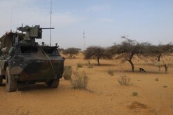 FILE - A light armored vehicle (LAV) of the French force of the counter-terrorism Barkhane mission in Africa's Sahel region Barkhane is parked at the roadside crossing of the town of Gossi, center Mali, March 25, 2019.