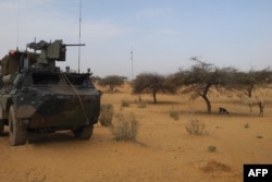 FILE - A light armored vehicle (LAV) of the French force of the counter-terrorism Barkhane mission in Africa's Sahel region Barkhane is parked at the roadside crossing of the town of Gossi, center Mali, March 25, 2019.