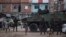 Brazilian marines stand in guard next to an armored vehicle a during surprise operation in Kelson's slum in Rio de Janeiro, Feb. 20, 2018.