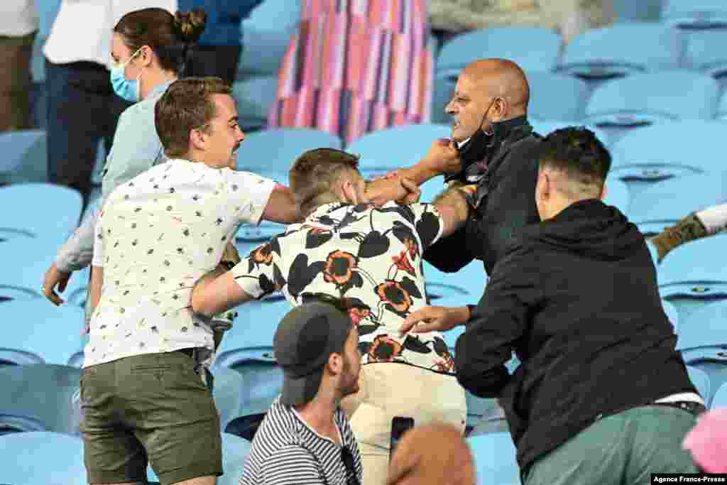 Members of the crowd fight over the wearing of masks on day one of the Australian Open tennis tournament in Melbourne.