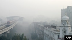 An Orange Line Metro Train is pictured on an elevated track amid smoggy conditions in Lahore, Pakistan, on November 3, 2024.