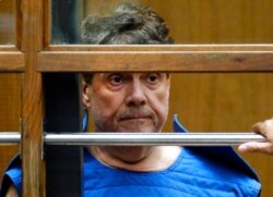 FILE - Dr. George Tyndall listens during his arraignment at Los Angeles Superior court in Los Angeles, July 1, 2019.