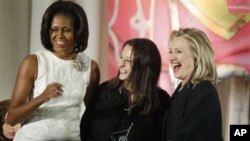 Secretary of State Hillary Rodham Clinton and first lady Michelle Obama present the 2012 International Women of Courage Award to Safak Pavey of Turkey, on the 101st Anniversary of International Women's Day, March 8, 2012, at the State Department in Washin