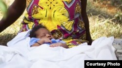 A Woman in African dress with a baby