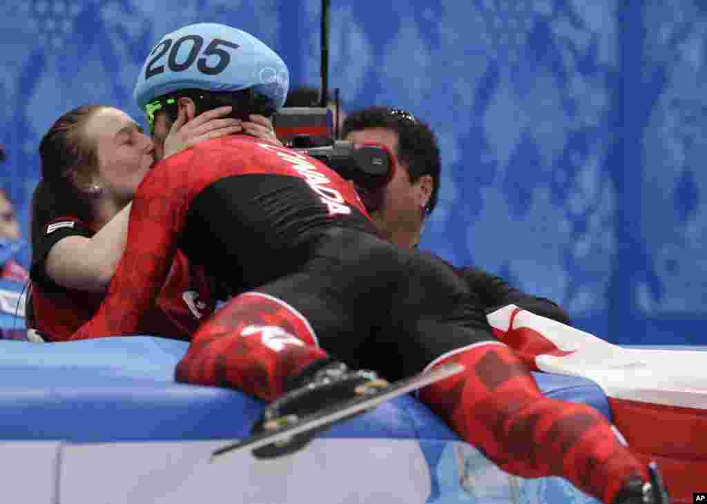 Charles Hamelin of Canada, right, embraces Marianne St. Gelais after he won the men&#39;s 1500m short track speedskating final at the Iceberg Skating Palace, Sochi, Russia, Feb. 10, 2014.