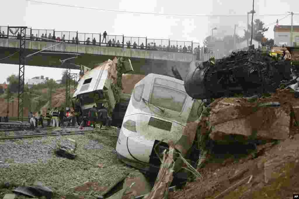 Emergency personnel respond to a train derailment in Santiago de Compostela, Spain, July 24, 2013.