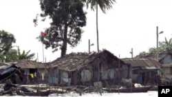 Shacks and houses line the shores of a river in Nigeria's Delta region. Militancy was born of resentment in the Niger Delta, where multi-billion dollar oil installations sit among villages of shacks perched on stilts over viscous, blackened water, April 3