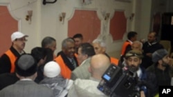 Arab League observers (orange vests) talk to people during a visit to Zabadani, near Damasus, Syria, January 21, 2012.