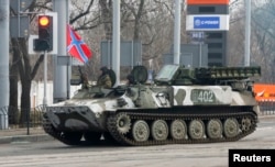 FILE - Pro-Russian rebels drive a Strela-10 self-propelled anti-aircraft system in Donetsk, Feb. 3, 2015.