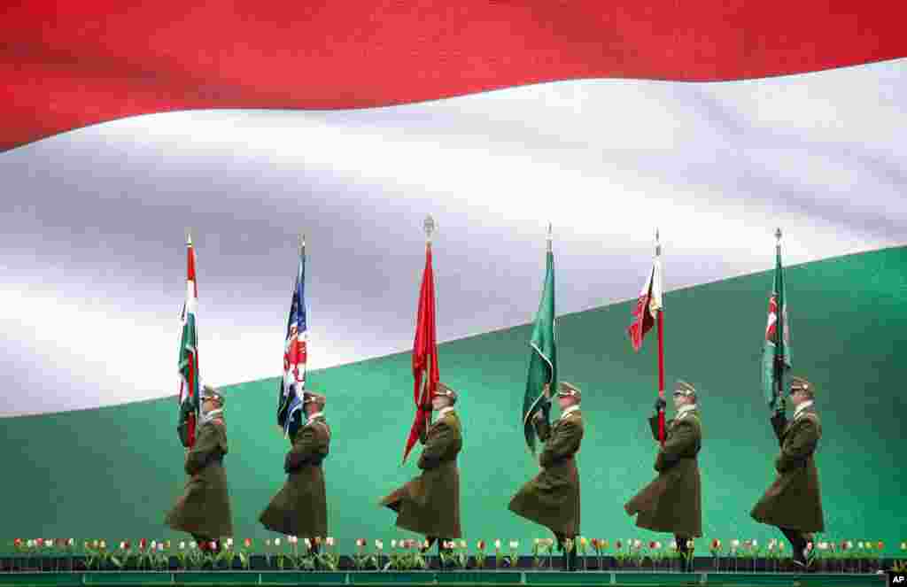 Hungarian soldiers march in Budapest, during a ceremony celebrating the country&#39;s national holiday.