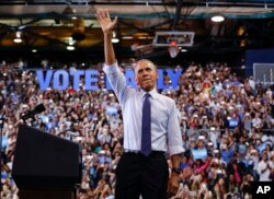 President Barack Obama waves to supporters at Florida International University in Miami, Nov. 3, 2016, during a campaign rally for Democratic presidential candidate Hillary Clinton.